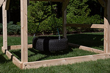 Triumph Play System's 360 degree tire swing under the play set fort.