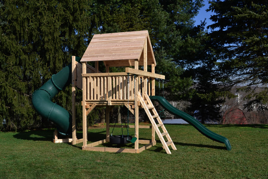 Cedar swing set for small yards with green tube slide and slide. 
