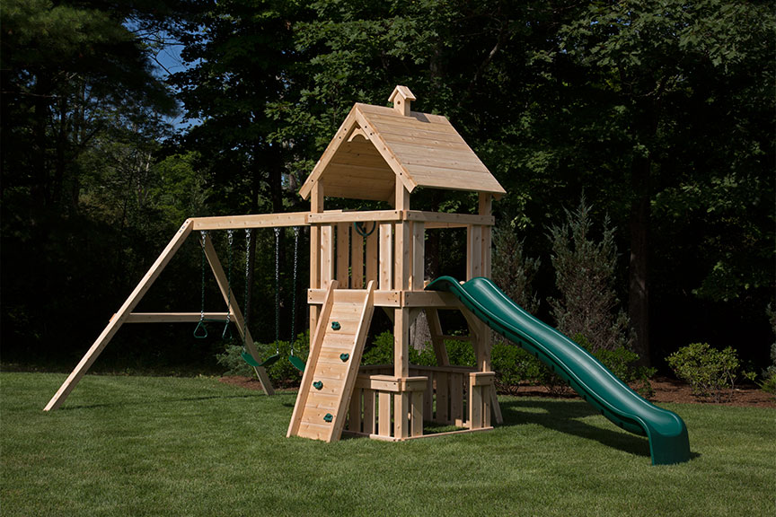 Swing set kit featuring rock wall, swings, and a wood roof.