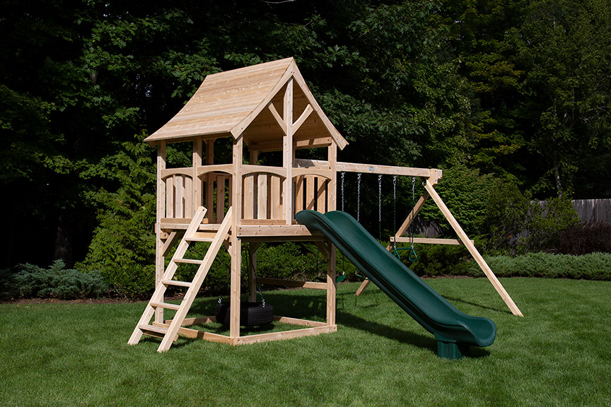 Cedar swing set with arched wood roof two swings and a green scoop slide.