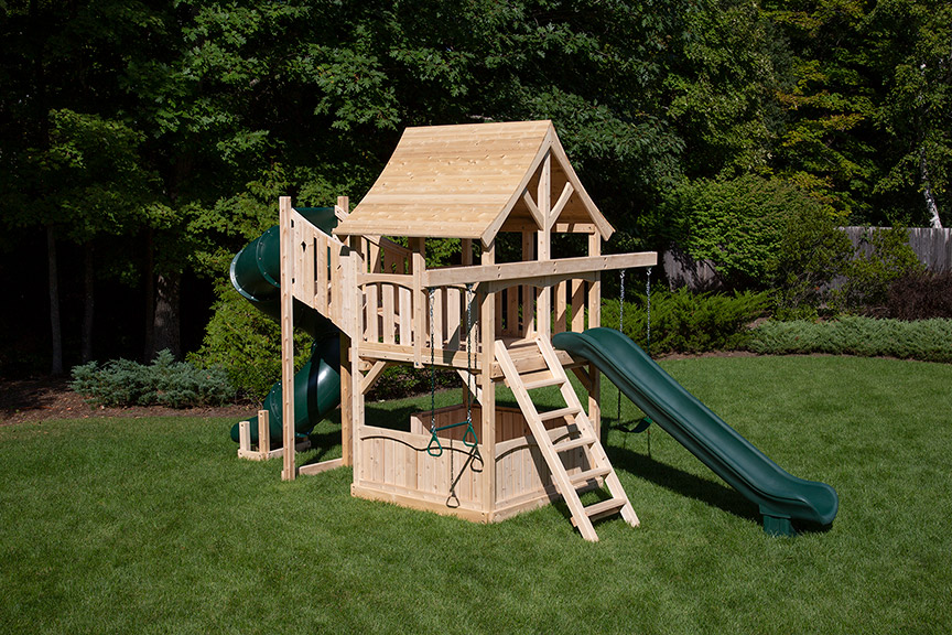Cedar swing set for small yards with arched wood roof, rock wall and rope ladder.