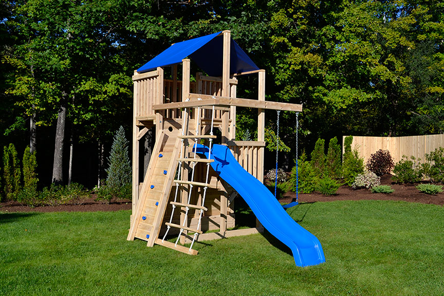 Swing set for small yards with a wooden rock wall.