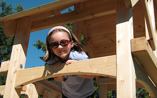 Girl with heart glasses playing.