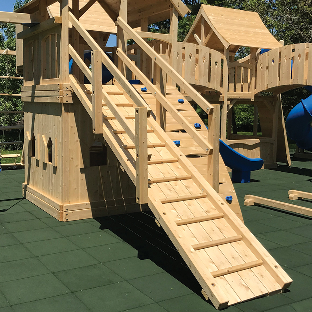 Wooden swing set ramp with post and hand rails.