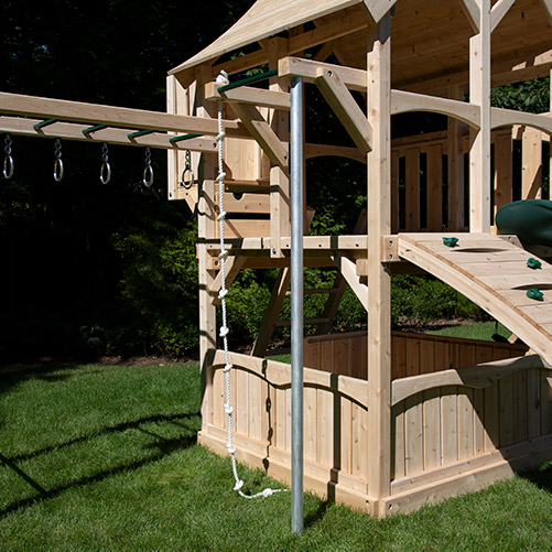 A play set fire pole with chin-up bar and climbing rope.