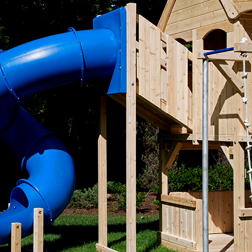 A tower attacted to a cedar swing set fort.