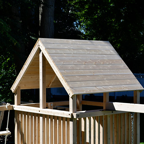 Wood roof over a cedar swing set.