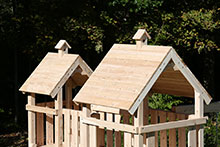 Wooden swing set with Rock wall climbing ladder.