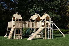 Three swing set towers with bridges and ramp.