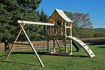 Triumph Play System's havendale climber cedar swing set with rockwall and slide.