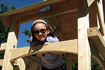 Triumph Play System's havendale climber cedar swing set with rockwall and slide.