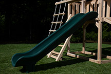 Triumph Play System's havendale climber cedar swing set with rockwall and slide.