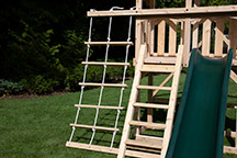 Triumph Play System's havendale climber cedar swing set with rockwall and slide.