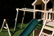 Triumph Play System's havendale loaded cedar swing set with rockwall and slide.