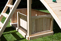 Triumph Play System's havendale loaded cedar swing set with rockwall and slide.