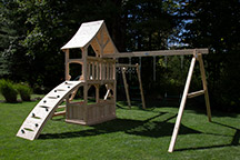 Triumph Play System's havendale loaded cedar swing set with rockwall and slide.