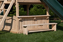 Triumph Play System's Kelton deluxe cedar swing set with counter and bench.