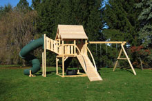 Cedar swing set with arched wood roof, tower with green tube slide and ramp.