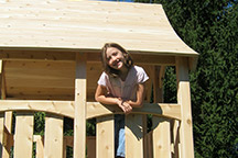 Triumph Play System's Kelton Space Saver cedar swing set for small backyards.