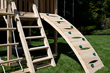 Triumph Play System's Kelton Space Saver Climber cedar swing arched rock wall.
