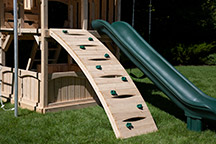 Triumph Play System's Kelton Space Saver Loaded cedar swing arched rock wall.