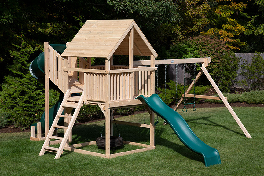 Cedar swing sets with green tube slide, green wave slide and wood woof.