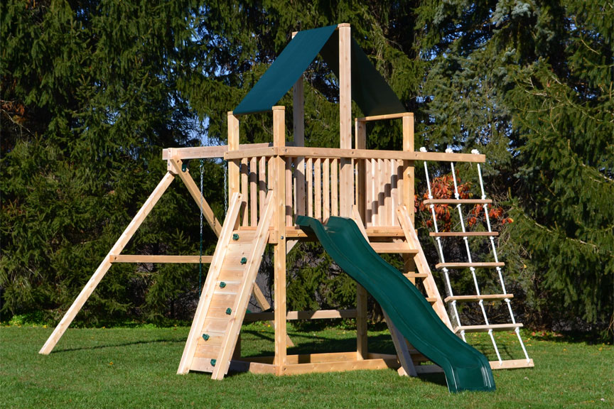 Cedar swing sets with green canopy roof, rock wall and rope ladder.