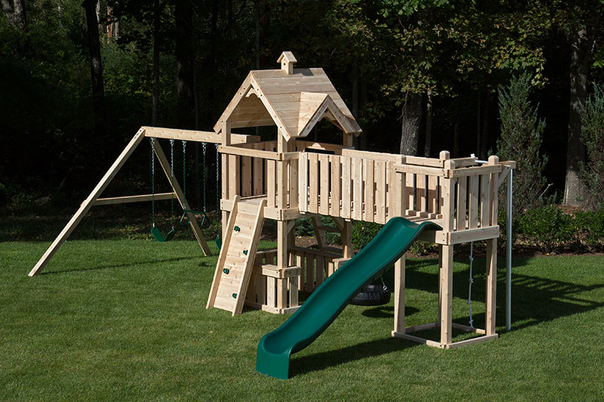 Cedar swing sets with green tube slide, green wave slide and wood woof.