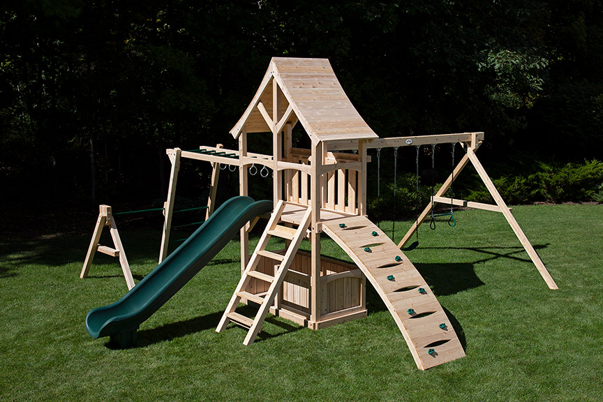 Cedar swing set with arched wood roof, rock wall and rope ladder.