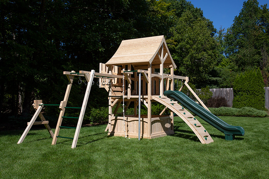 Cedar swing set with arched wood roof, rock wall and rope ladder.