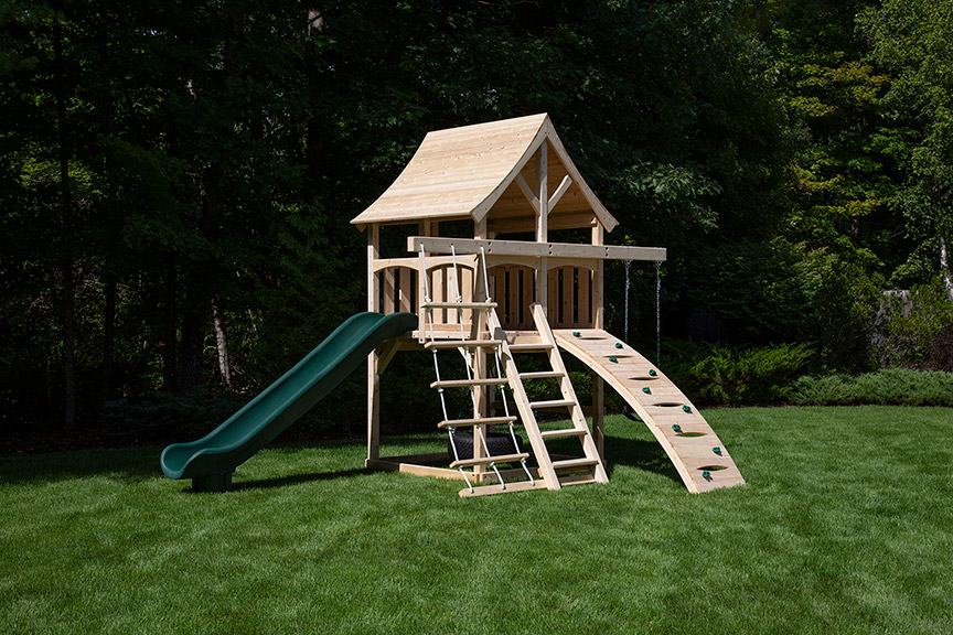 Cedar swing set for small yards with arched wood roof and green scoop slide.