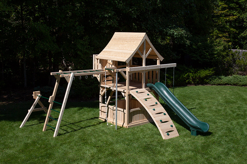 Cedar swing set for small yards with arched wood roof, rock wall and monkey bars.