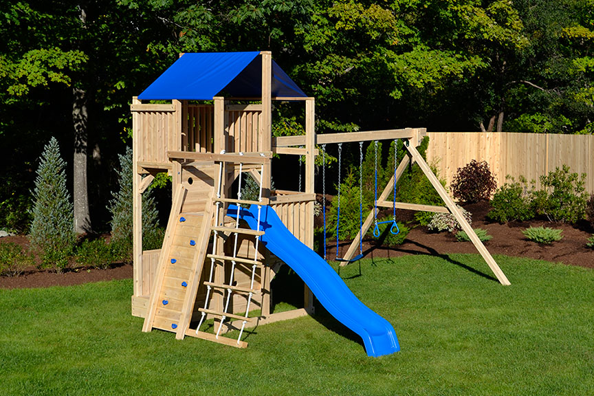 Cedar swing set with rock wall and rope ladder.