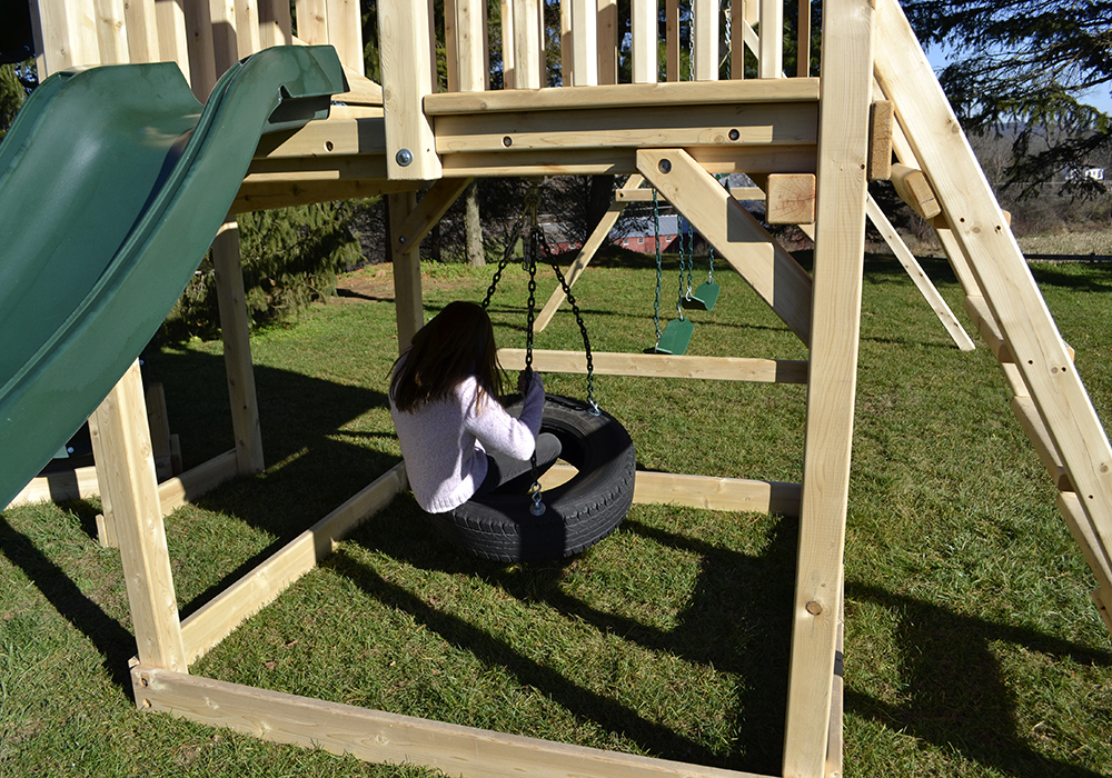 Triumph Play System's Bailey swing set with tire swing and large play deck.