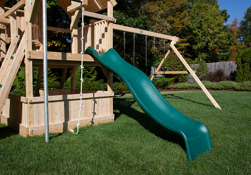 Green slide on a cedar swing set