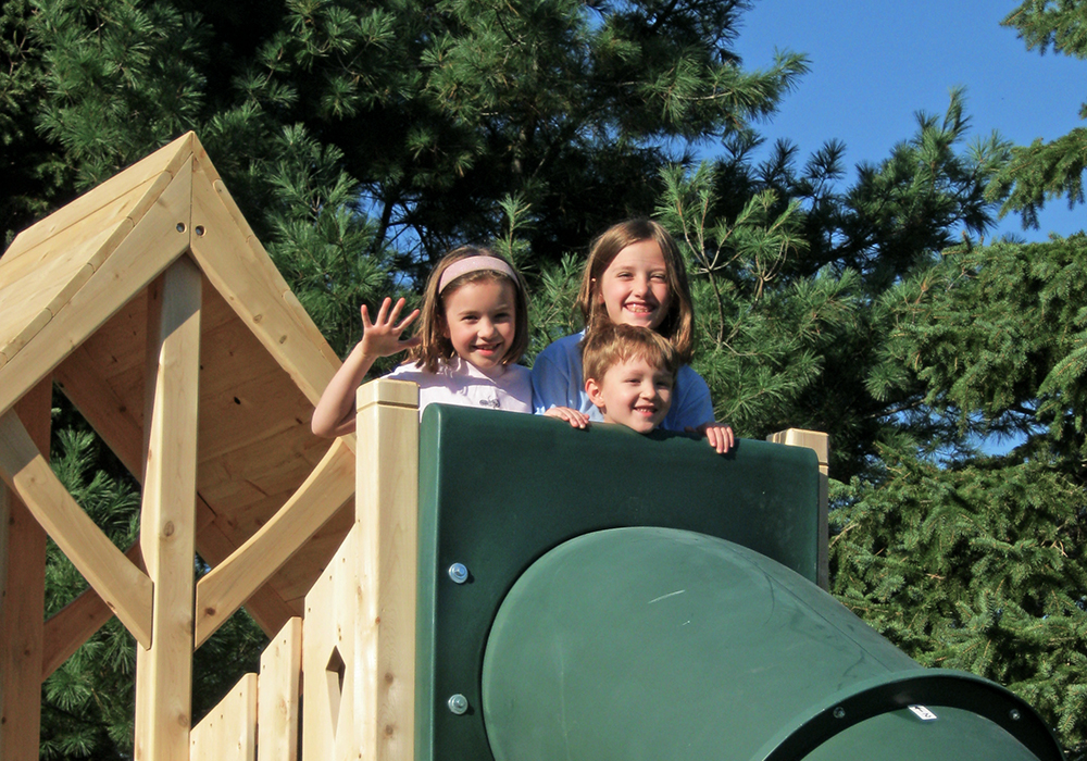 Triumph Play System's Havendale Deluxe cedar swing set with tower and tube slide.