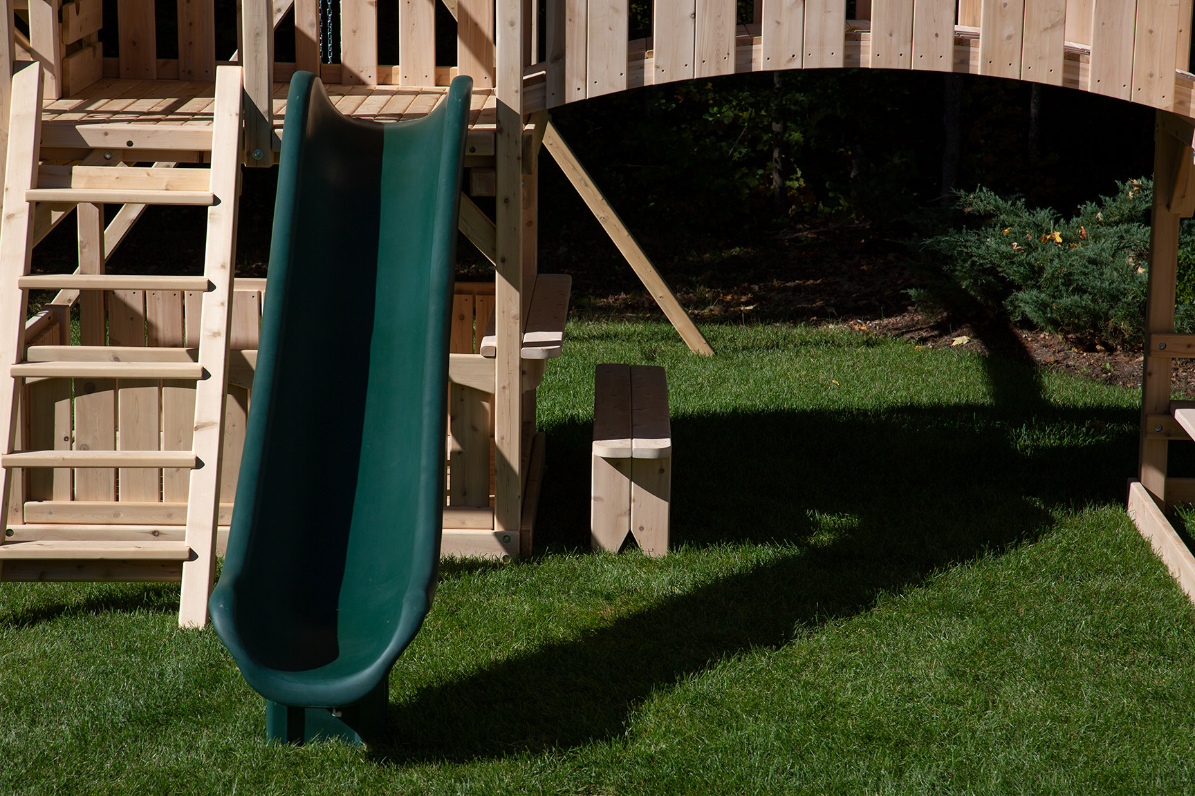 Triumph Play System's diamond tower and green tube slide.