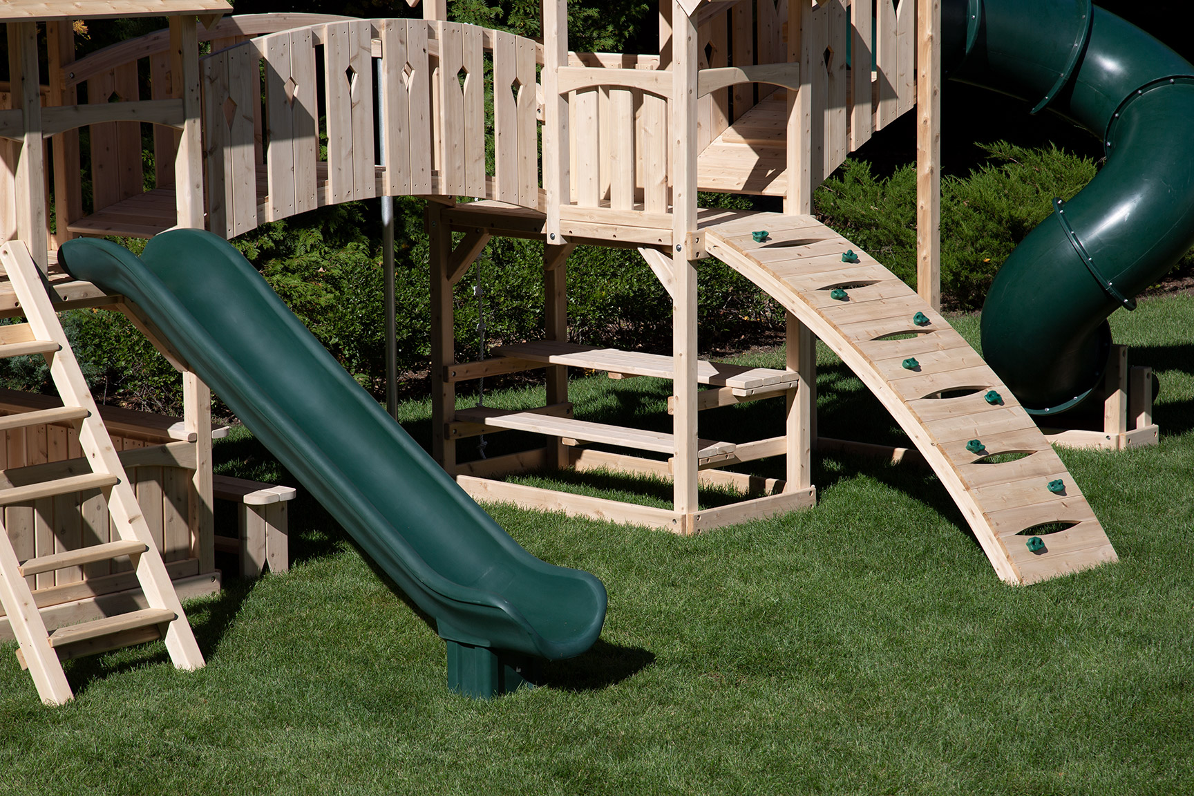 Triumph Play System's diamond tower and green tube slide.