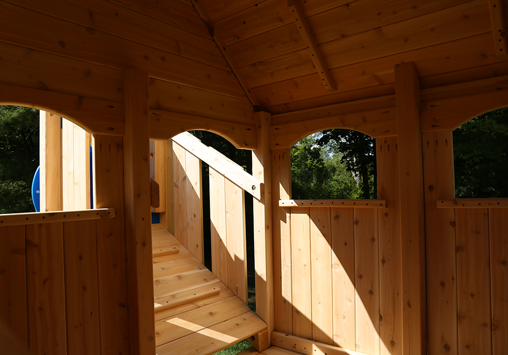 Triumph Play System's Nottingham Deluxe cedar swing set with wood roof.