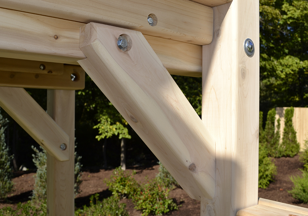 Triumph Play System's quad tower cedar swing set with wave slide.